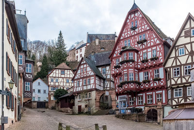 Houses in old town against cloudy sky