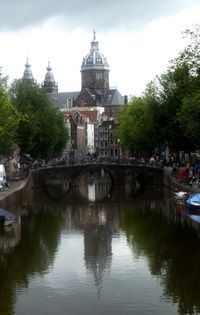 Bridge over river with buildings in background