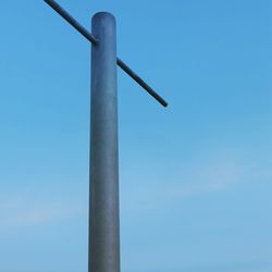 Low angle view of windmill against blue sky
