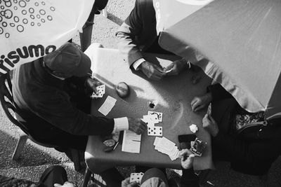 High angle view of men playing cards at table