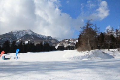 Scenic view of snow covered mountains against sky