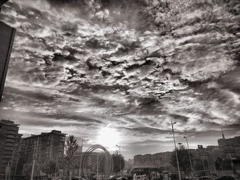 Buildings against cloudy sky