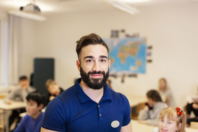 Teacher standing in classroom