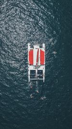 Drone view of red boat sailing in sea