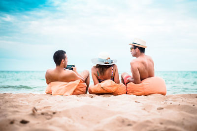 People at beach against sky