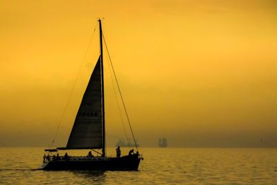 Lone sailboat in calm sea at dusk