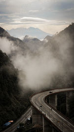 High angle view of road amidst mountains against sky