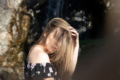 Close-up portrait of young woman standing outdoors