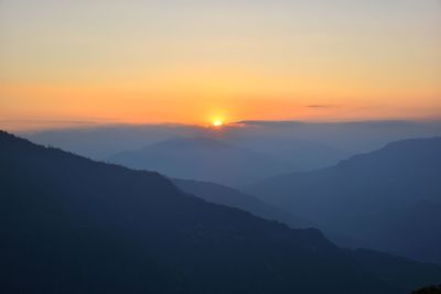 Scenic view of silhouette mountains against sky during sunset