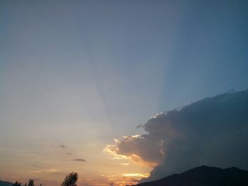 Scenic view of mountains against sky at sunset