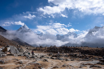 Scenic view of mountains against cloudy sky