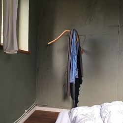 Clothes drying on wall by window at home