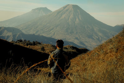 Rear view of man on arid landscape
