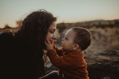 Side view of mother and child outdoors