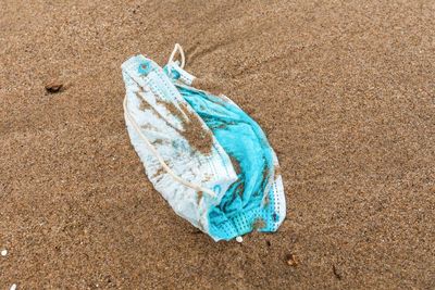 High angle view of blue umbrella on sand