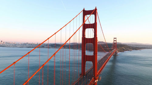 View of suspension bridge against sky during sunset