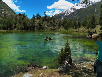 Scenic view of lake and mountains against sky