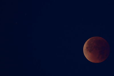 Low angle view of moon against clear sky at night