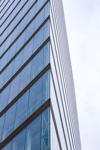 Low angle view of glass building against clear sky