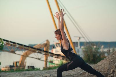 Mature woman exercising on beach