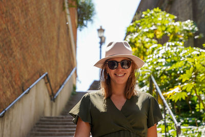 Portrait of young woman walking trees