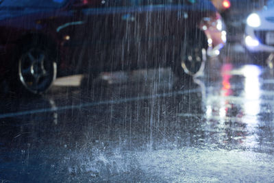 Wet car on street during rainy season