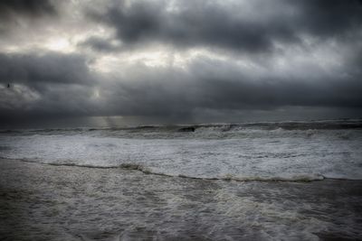 Scenic view of sea against cloudy sky