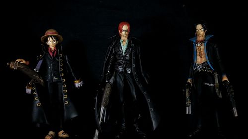 Low angle view of figurines against black background