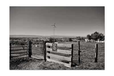 Fence on field against clear sky