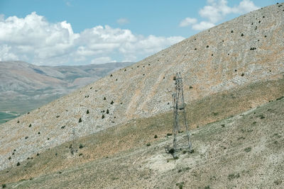 Lamppost and clouds on mountain