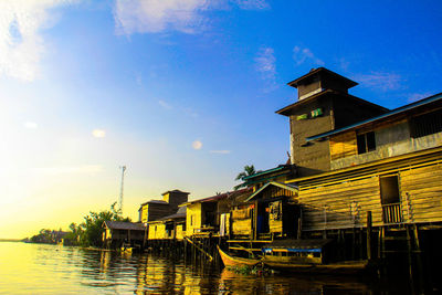 Buildings against sky at sunset