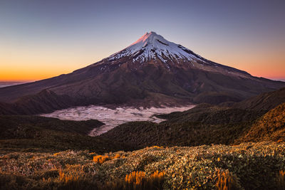 Scenic view of snowcapped mountains against sky during sunset