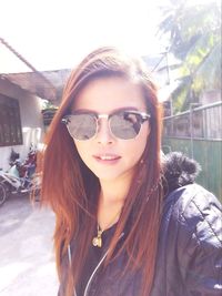 Portrait of smiling young woman in sunglasses