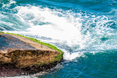 High angle view of sea by rock formation