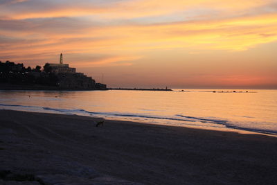 Scenic view of sea against orange sky