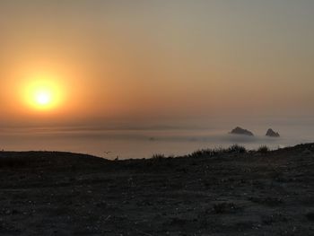 Scenic view of silhouette land against sky during sunset