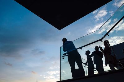 Low angle view of men against sky