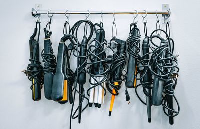 Electric hair tools at salon hanging on rack