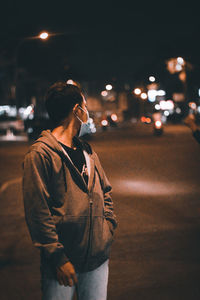 Full length of man standing on road at night