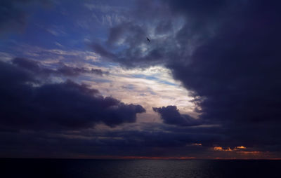 Scenic view of sea against cloudy sky