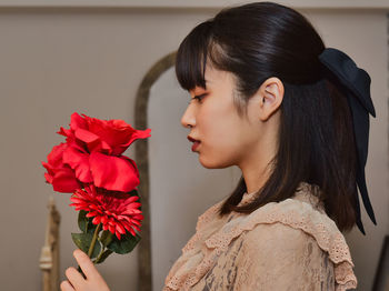 Portrait of young woman with flowers