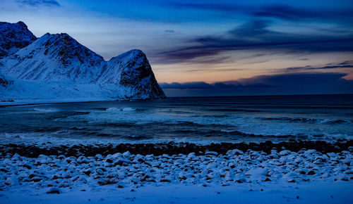 Scenic view of mountains against cloudy sky