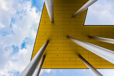 Low angle view of yellow building against sky