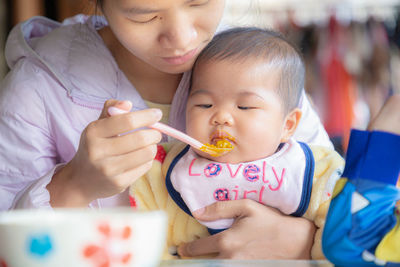 Close-up of cute girl holding baby boy