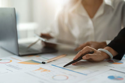 Midsection of businesswoman working at office