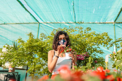 Woman looking at flowering plants