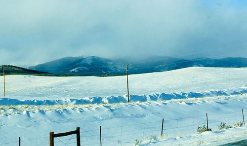 Scenic view of snow covered mountains against sky