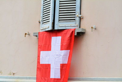 Swiss flag hanging from window