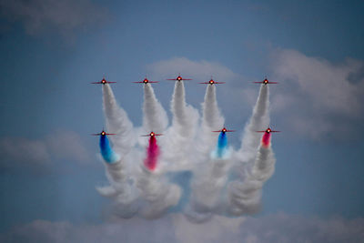 Low angle view of airshow against sky