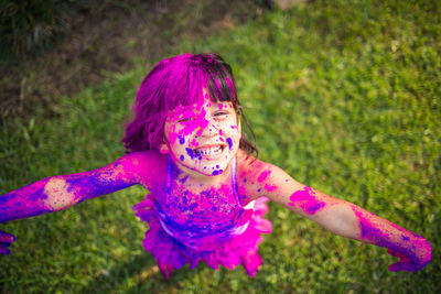 Portrait of happy girl enjoying holi